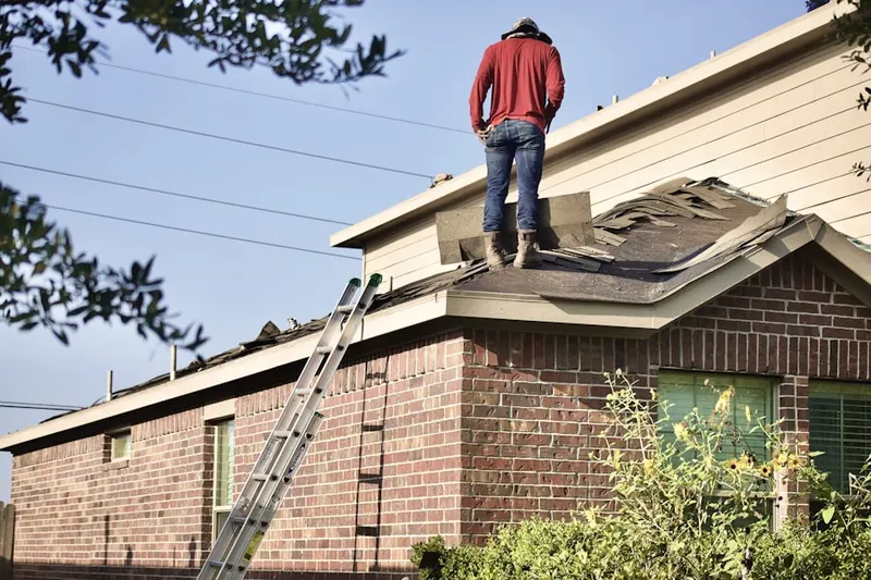 Professional roofer working on a residential roof in Fairham Heights